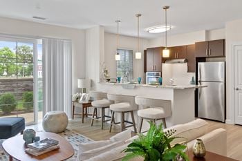 A kitchen and living room in a 555 waverly unit